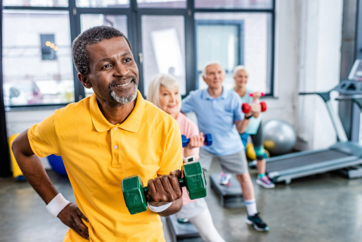 Elderly people working out in a gym.