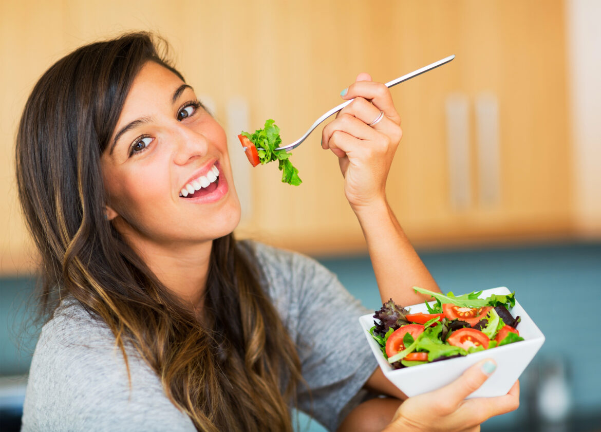 Woman eating a healthy salad.